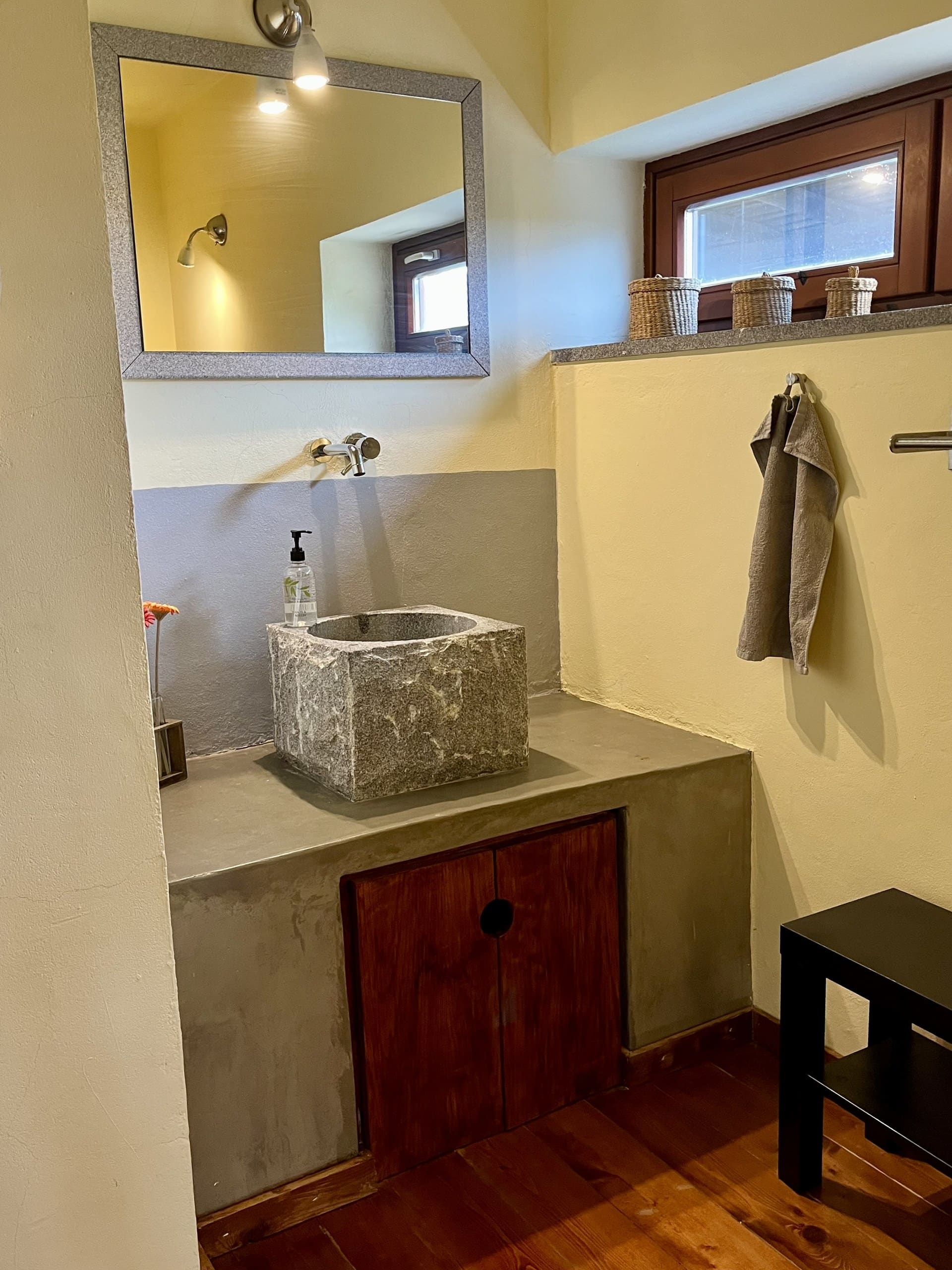 Waschbecken aus Granit auf einer Betonplatte im Bad der Casa Hridaya.